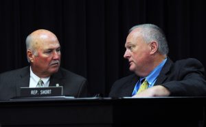 Senator Johnny Ray Turner (left) confers with Rep. John Short during the Oct. 4 Interim Joint Committee on Transportation.