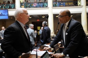 Sen. Dennis Parrett discusses legislation with Sen. Reggie Thomas during a brief recess in the Senate.