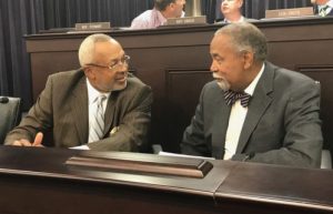 Senate Democratic Caucus Chair Gerald A. Neal confers with Rep. Arnold Simpson during the October meeting of the Interim Joint Committee on Transportation. 