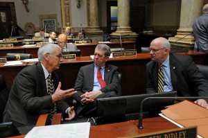 Senator Dorsey Ridley (center), D-Henderson, confers with Senator Dennis Parrett (right), D-Elizabethtown, and Senator Paul Hornback, R-Shelbyville, during a brief recess on the Senate floor.